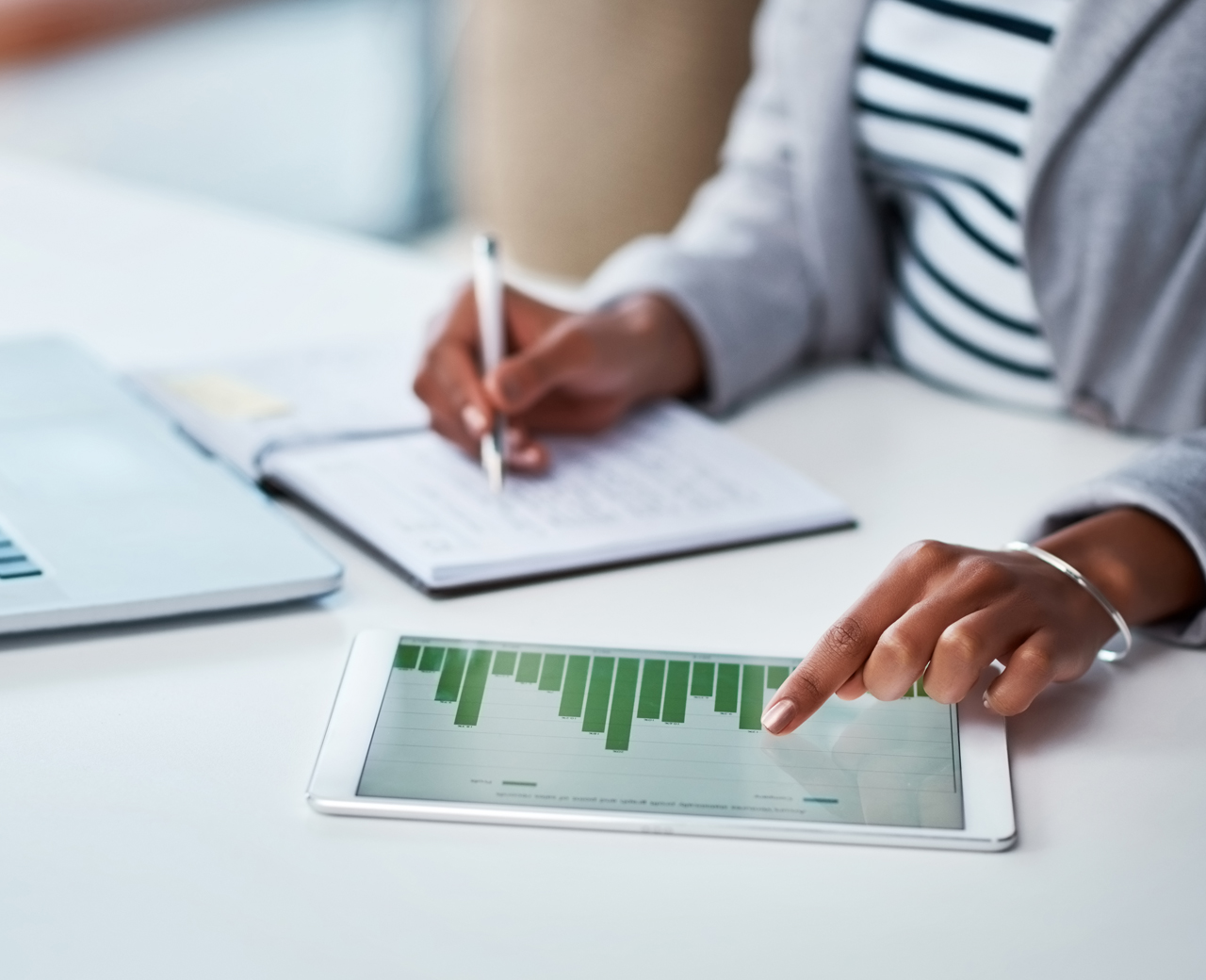 persons hands looking at graphs