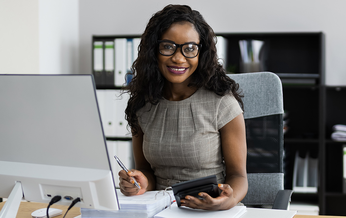 smiling woman in front of computer