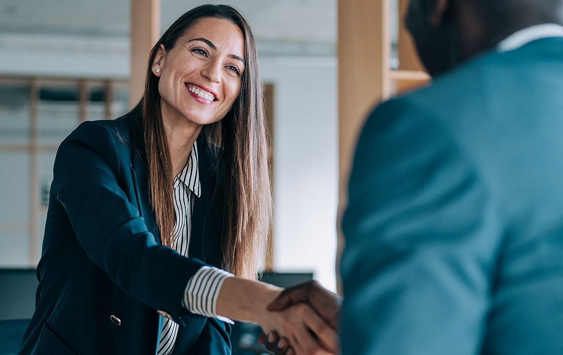 financial professional shaking hands with client
