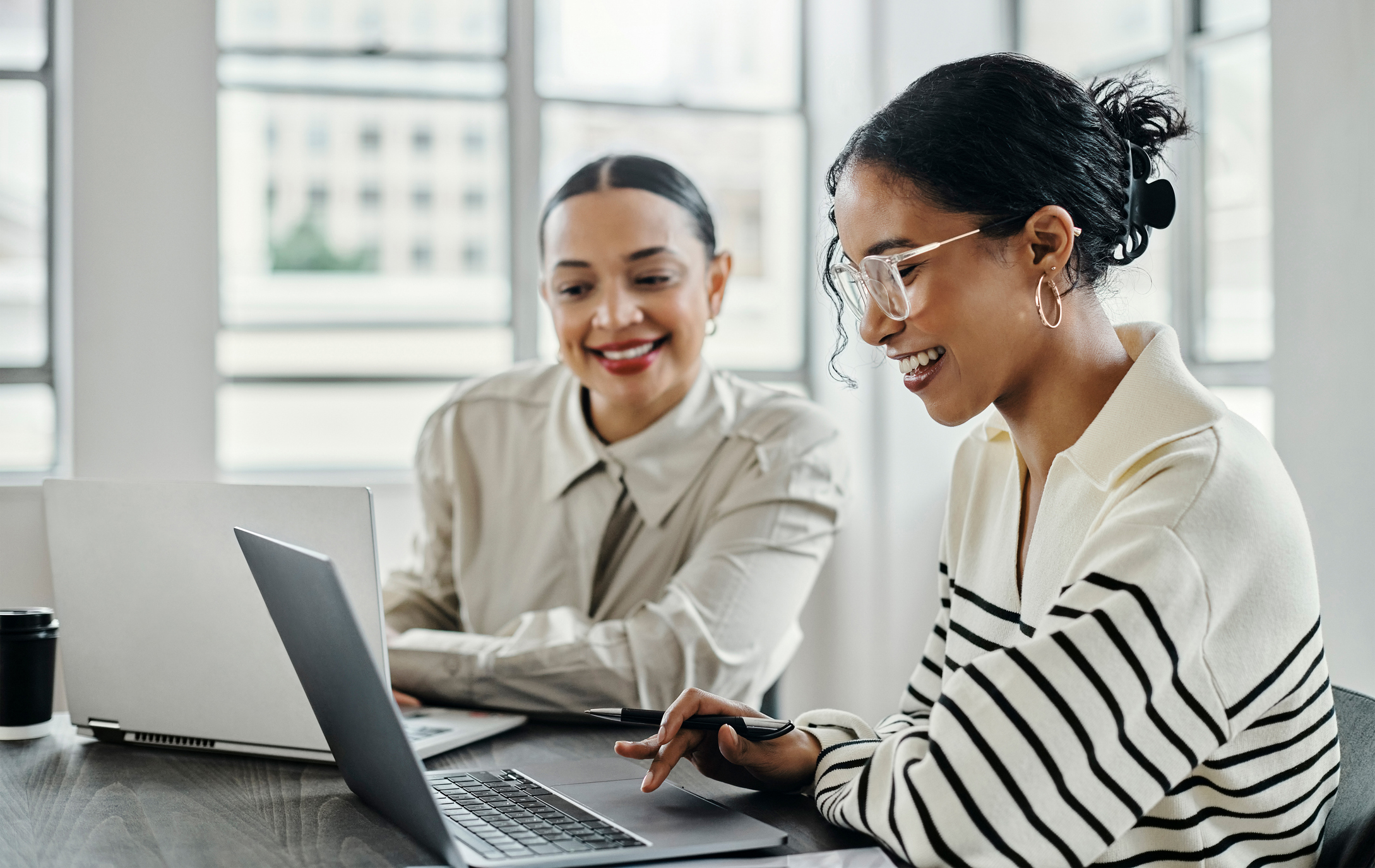 Two female advisors working together on a client project