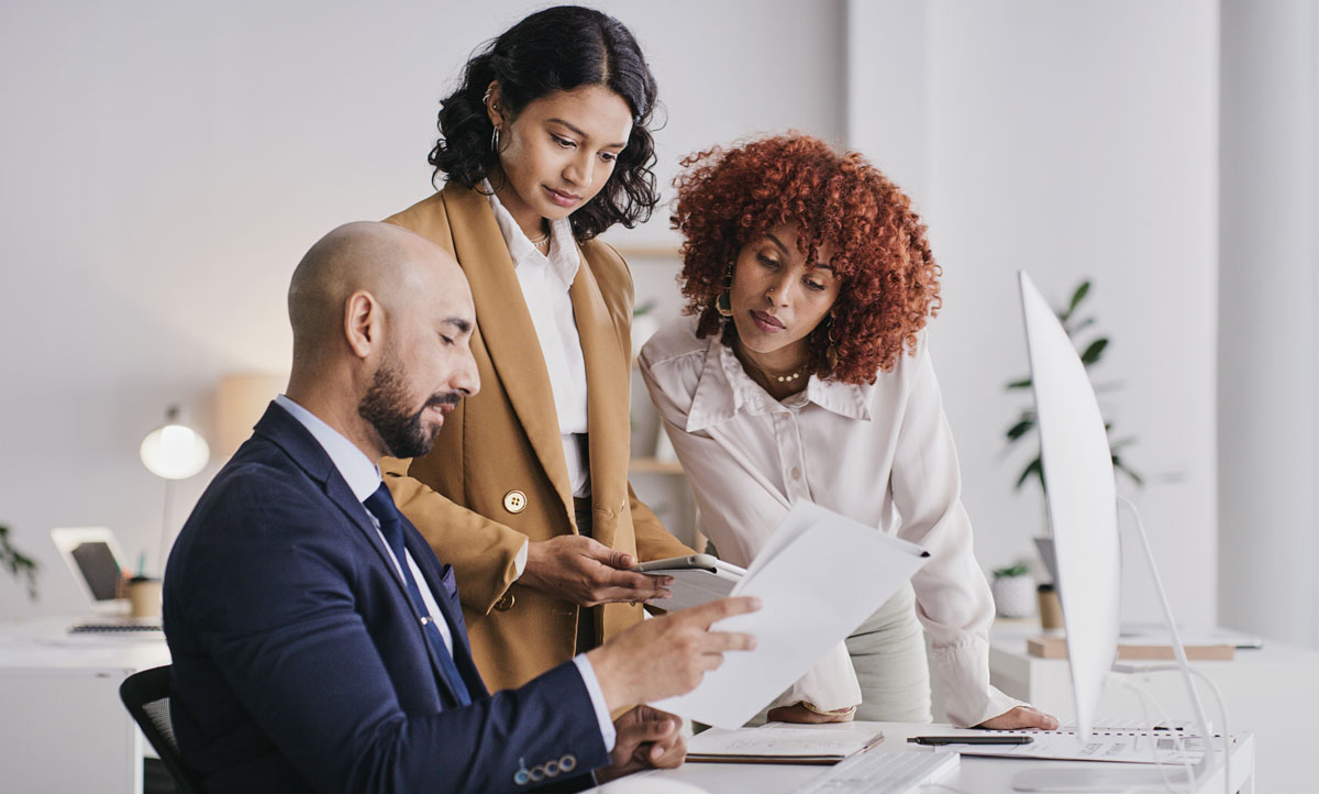 Advisors and clients looking at a document