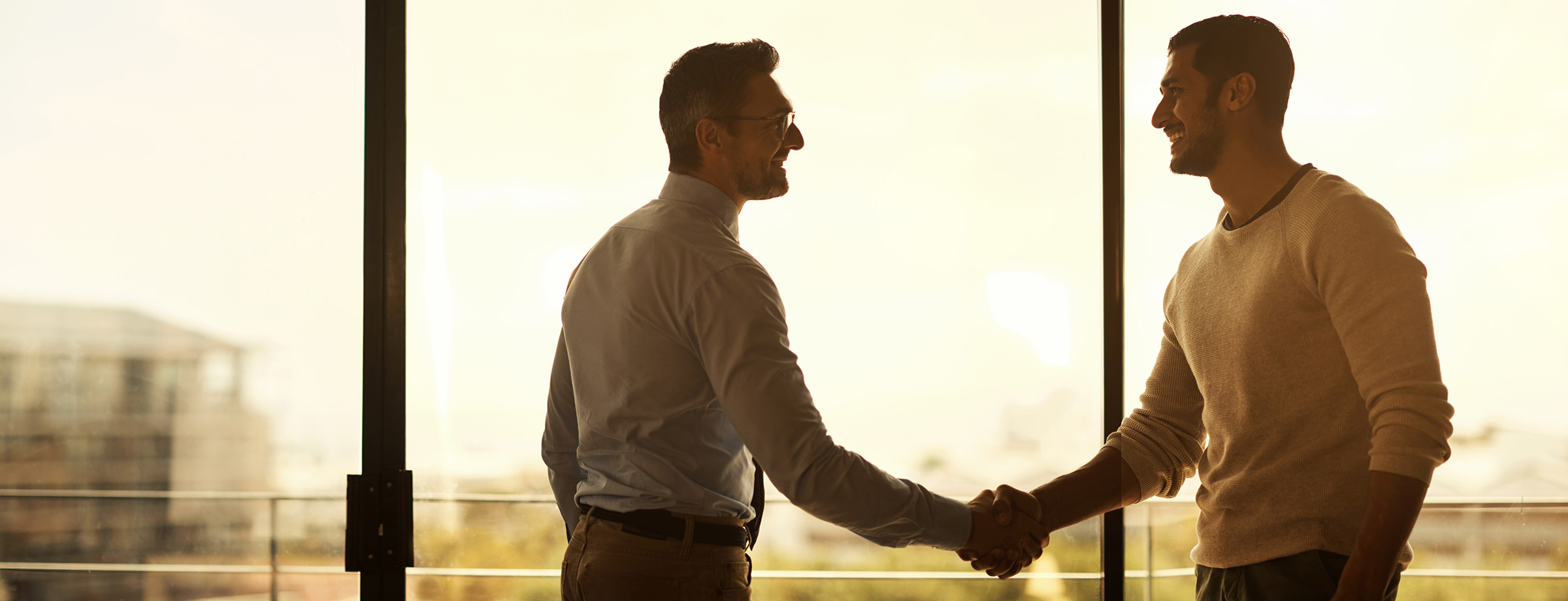 Photo of two gentleman shaking hands.